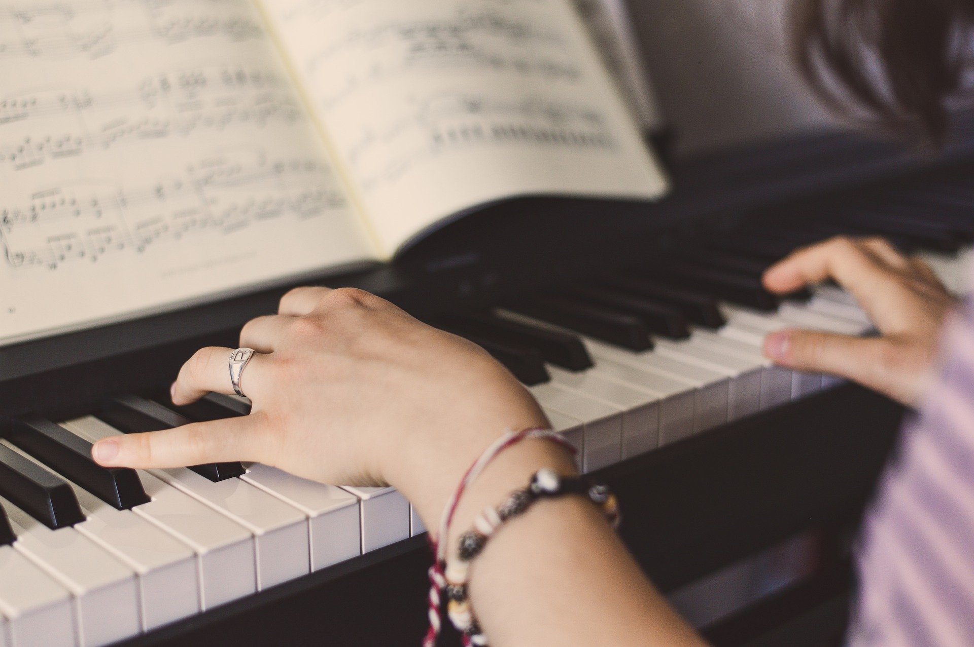 Woman reading music playing piano